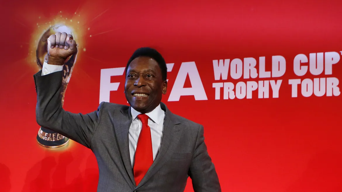 Brazilian soccer legend Pele reacts as he poses after a news conference to present the FiFA World Cup global 